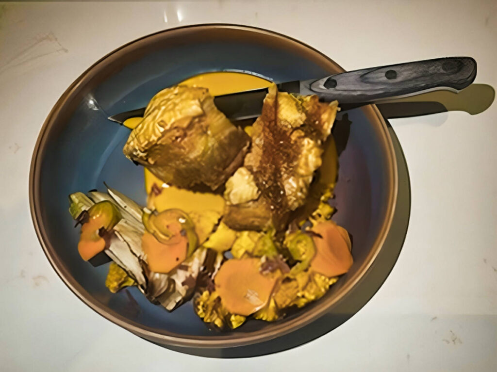 A plate with crispy pork belly with carrot, ginger puree, roasted fennel, and cauliflower