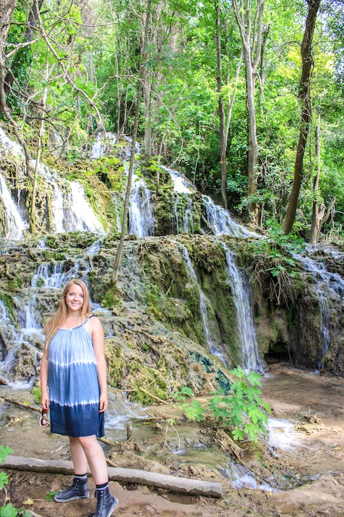 Taylor stands in front of small waterfalls in Krka National Park
