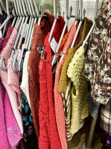 Colorful crocheted vintage garments hung in the market