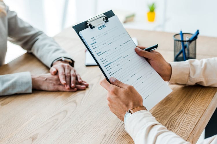 Man holding clipboard with resume letters