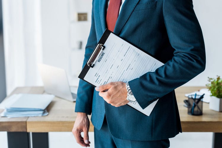 Man holding clipboard with resume
