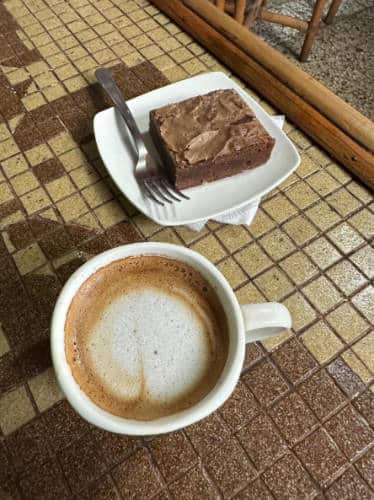A cup of cortado and a brownie served in Crossroads Cafe