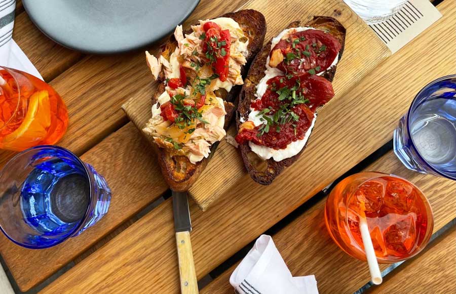 Crostini and drinks on a table in bar avec in River North