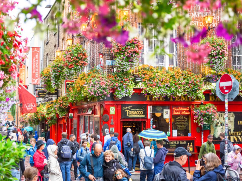 View of the crowd at the Temple Bar surrounded by colorful flowers
