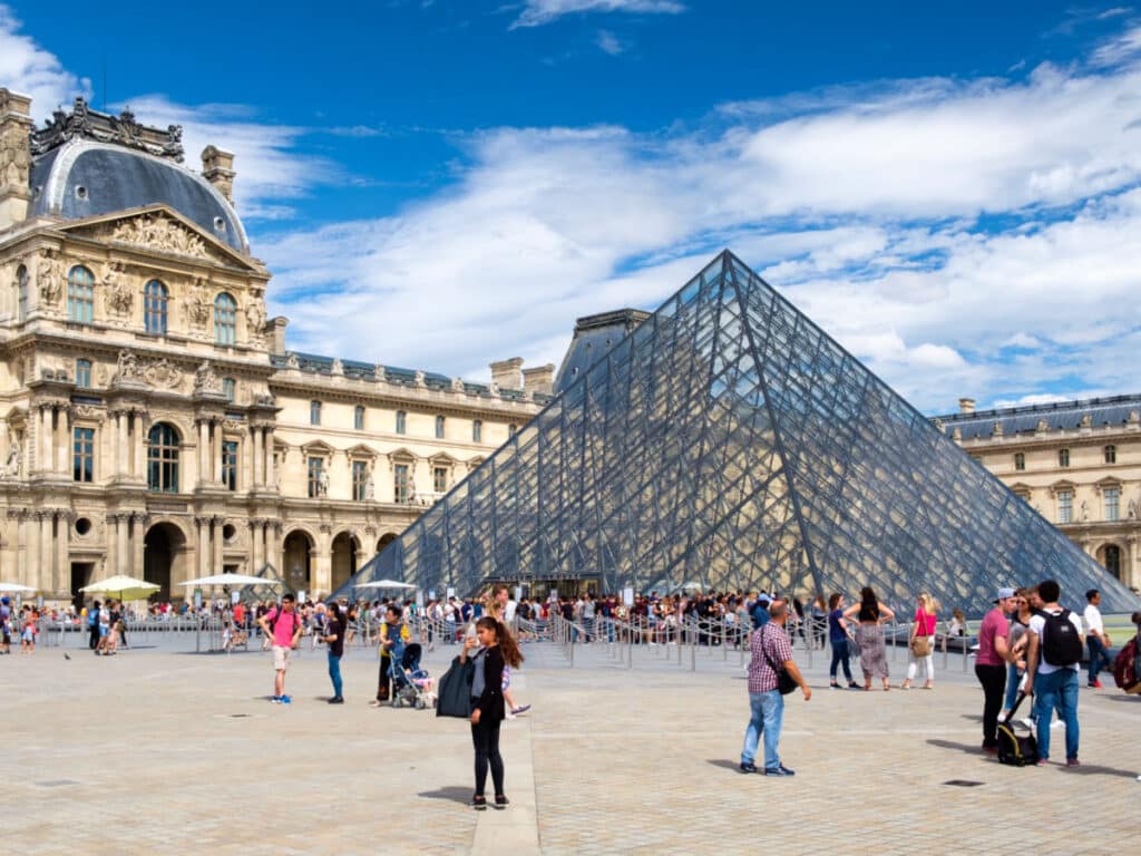 View of the crowd near the iconic Louvre Museum in Paris