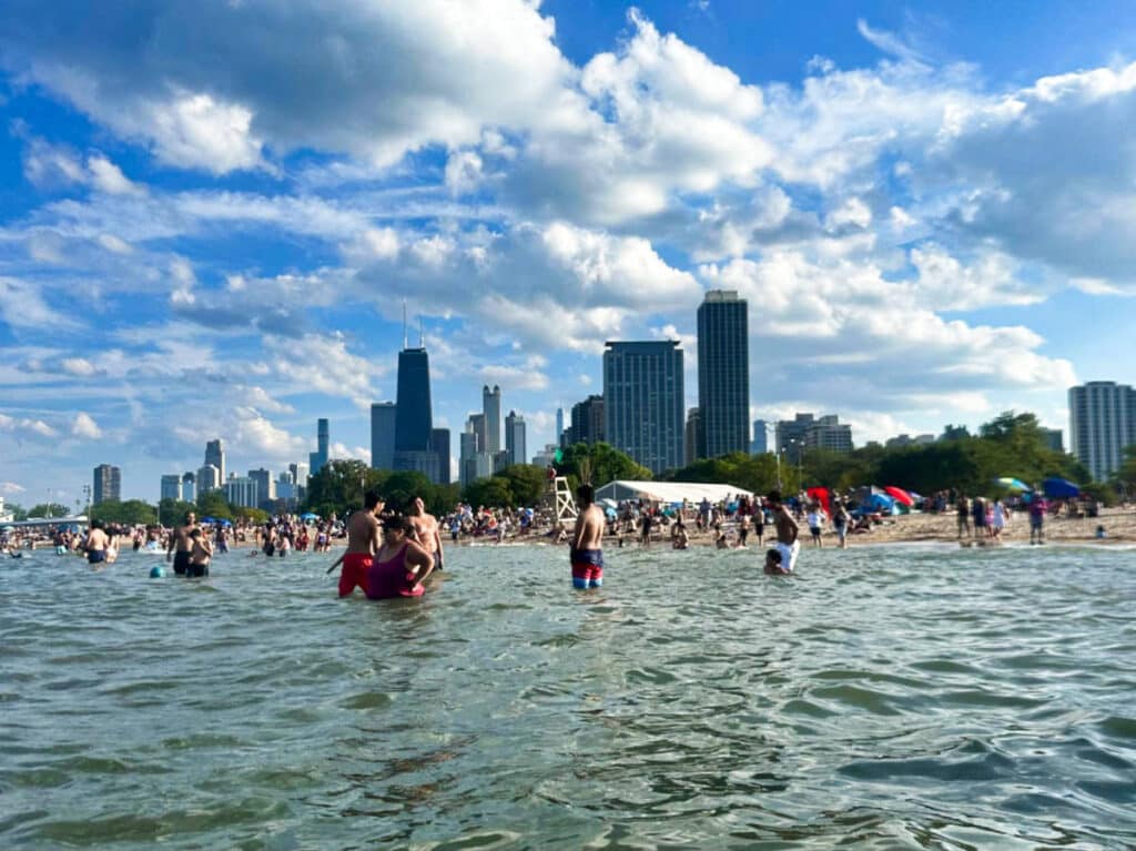View of the crowd enjoying at the North Avenue Beach with the Chicago skyline in the background