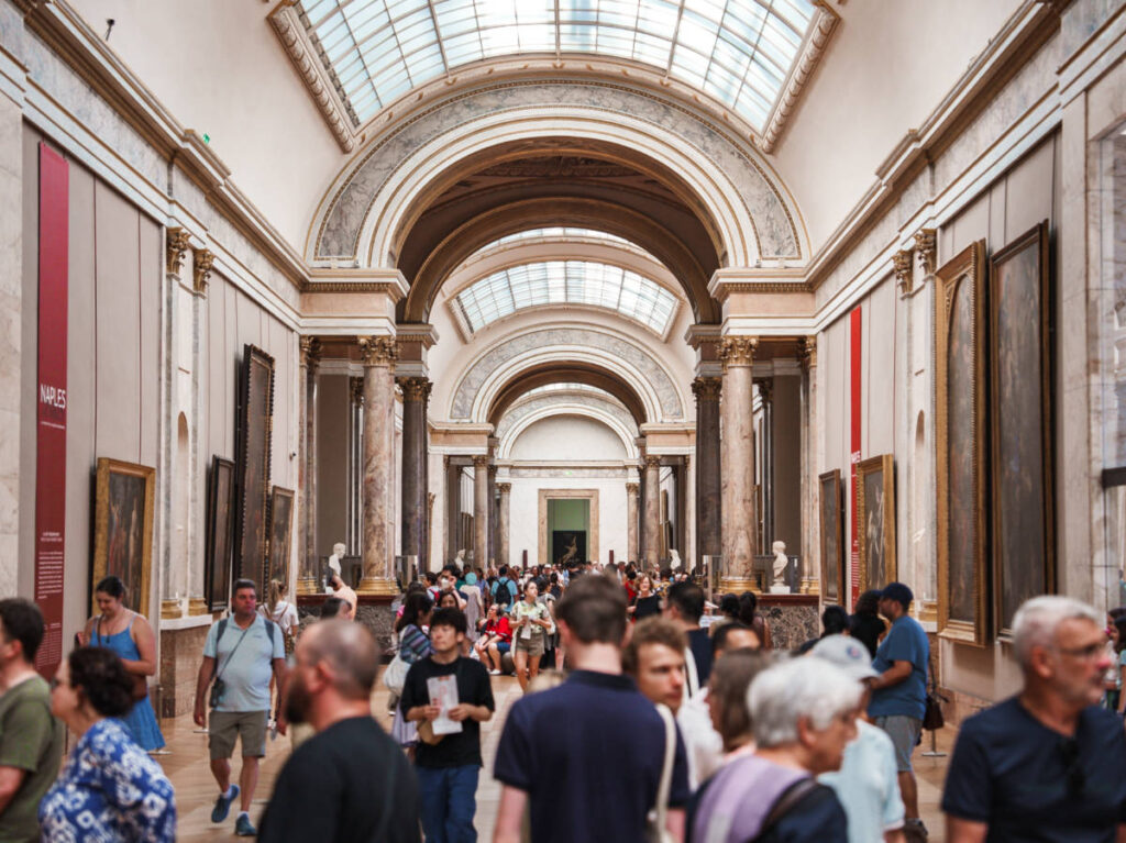 The crowd walking inside the museum in Paris