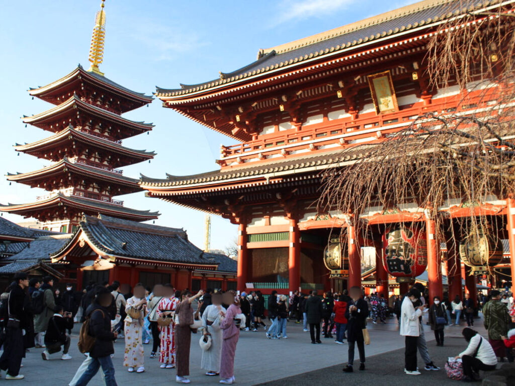 View of the crowd wandering outide the intricate temple of Senso-Ji