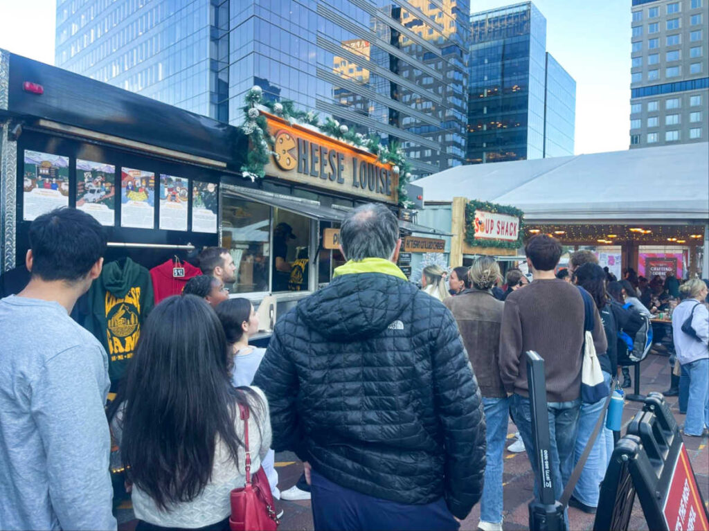 The crowd in front of the food trucks in the Snowport Holiday Market