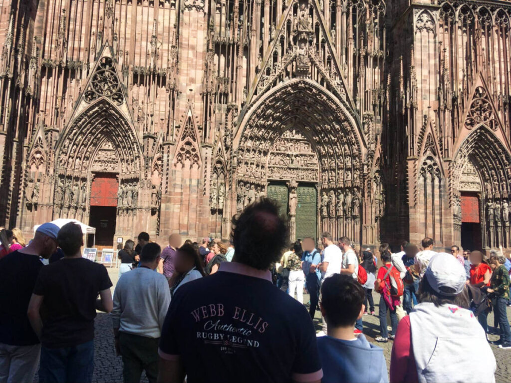 View of the crowd walking and admiring the intricate exterior of the cathedral