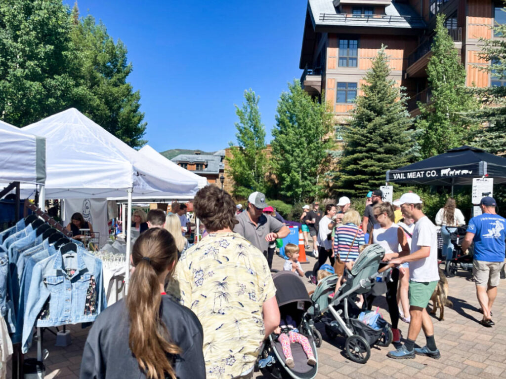 View of the crowd walking around the stalls at the Vail Farmers’ Market