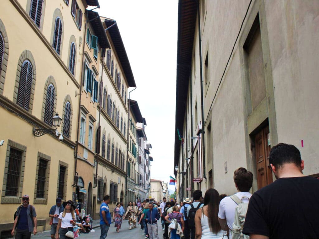 View of the crowd walking along the street in Florence