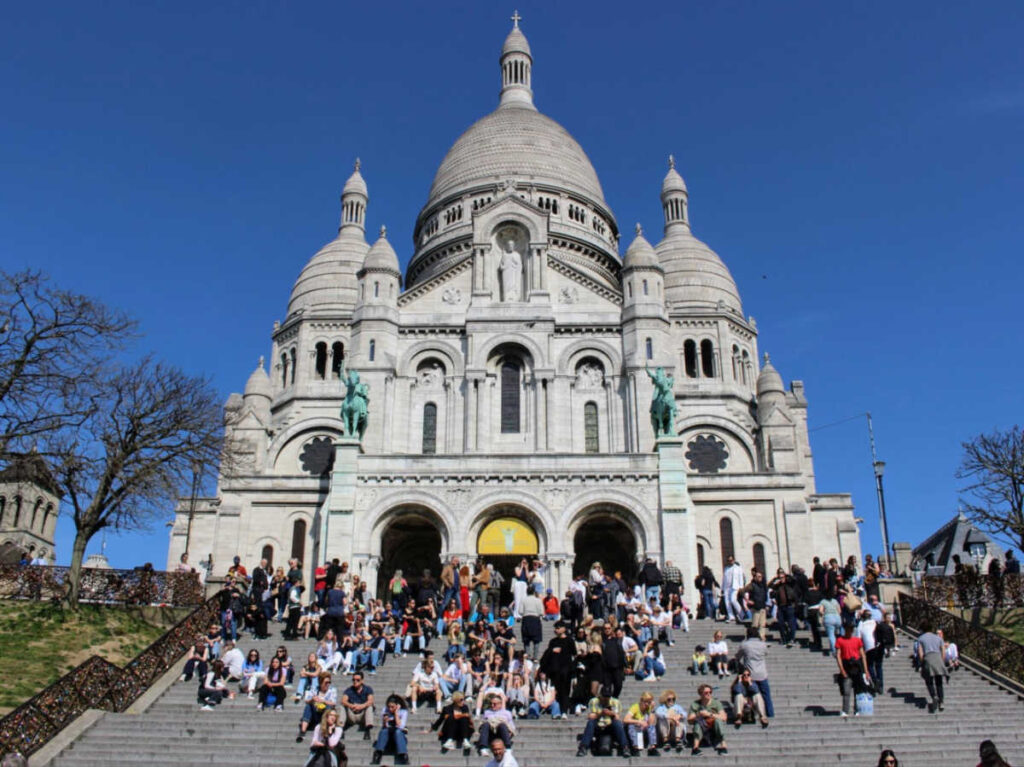 View of the crowded steps of the Sacré Coeur Basilica