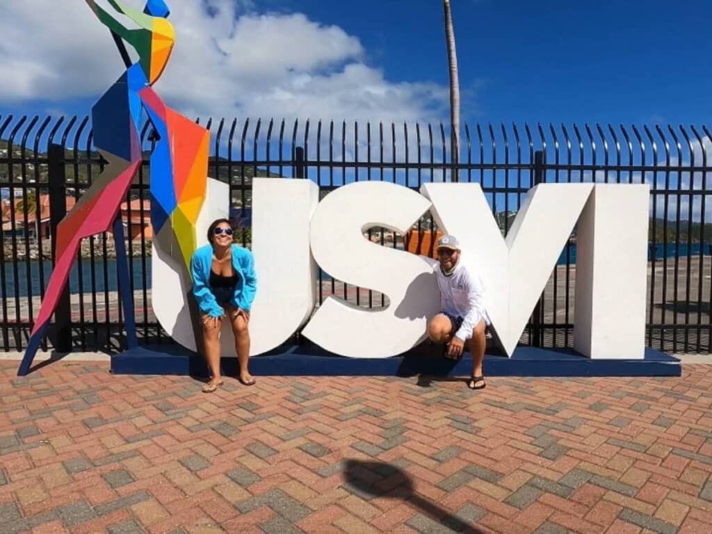 The author, Andrew Bloem with his wife and the USVI signage in Crown Bay on St. Thomas