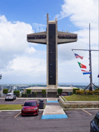Exterior view of the Cruceta del Vigia with a cloudy blue sky in the background