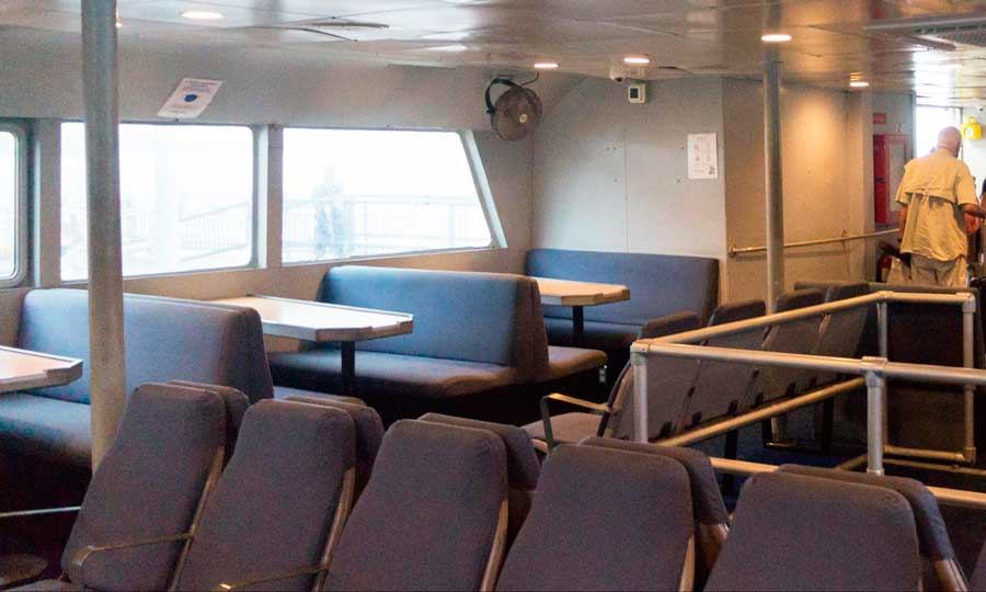 View of seats and tables from the interior of a ferry in Culebra