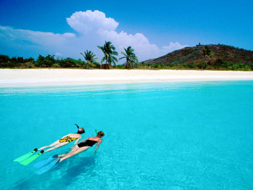 Women snorkeling on the clear blue water in Culebra