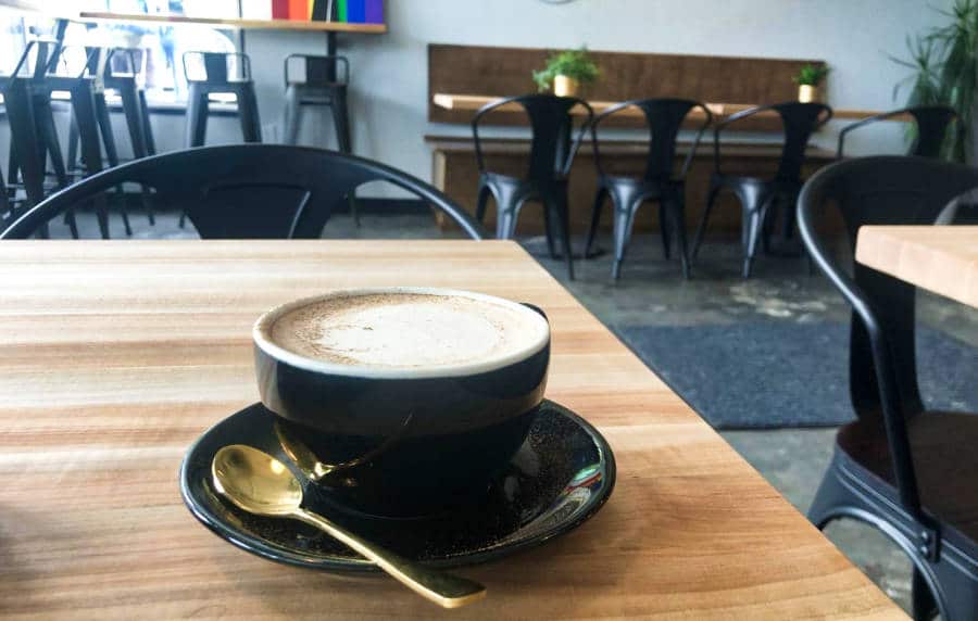 A cup of coffee on the wooden table inside a café in Seattle