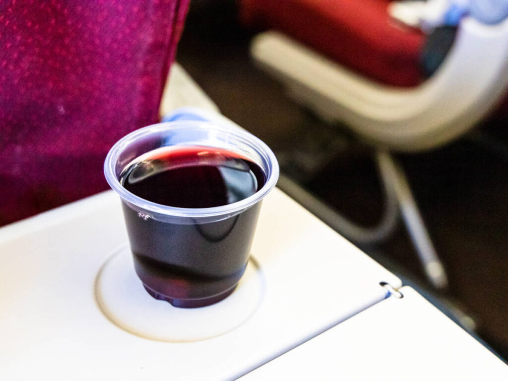 A cup of red wine in flight