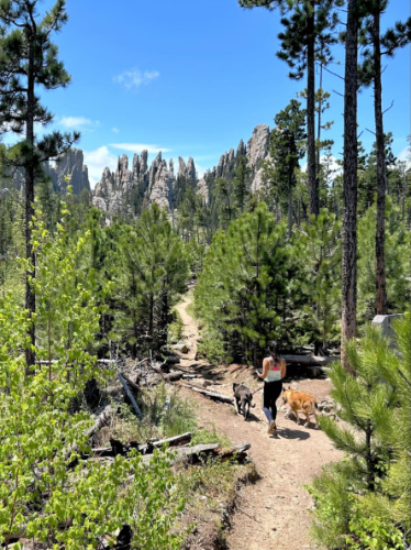 Travel Lemming editor, Abigail Bliss with her dogs during a hike in Custer State Park