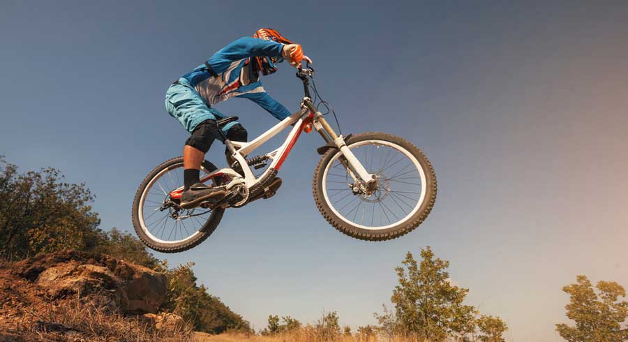 A cyclist jumping with his mountain bike in Valmont Bike Park