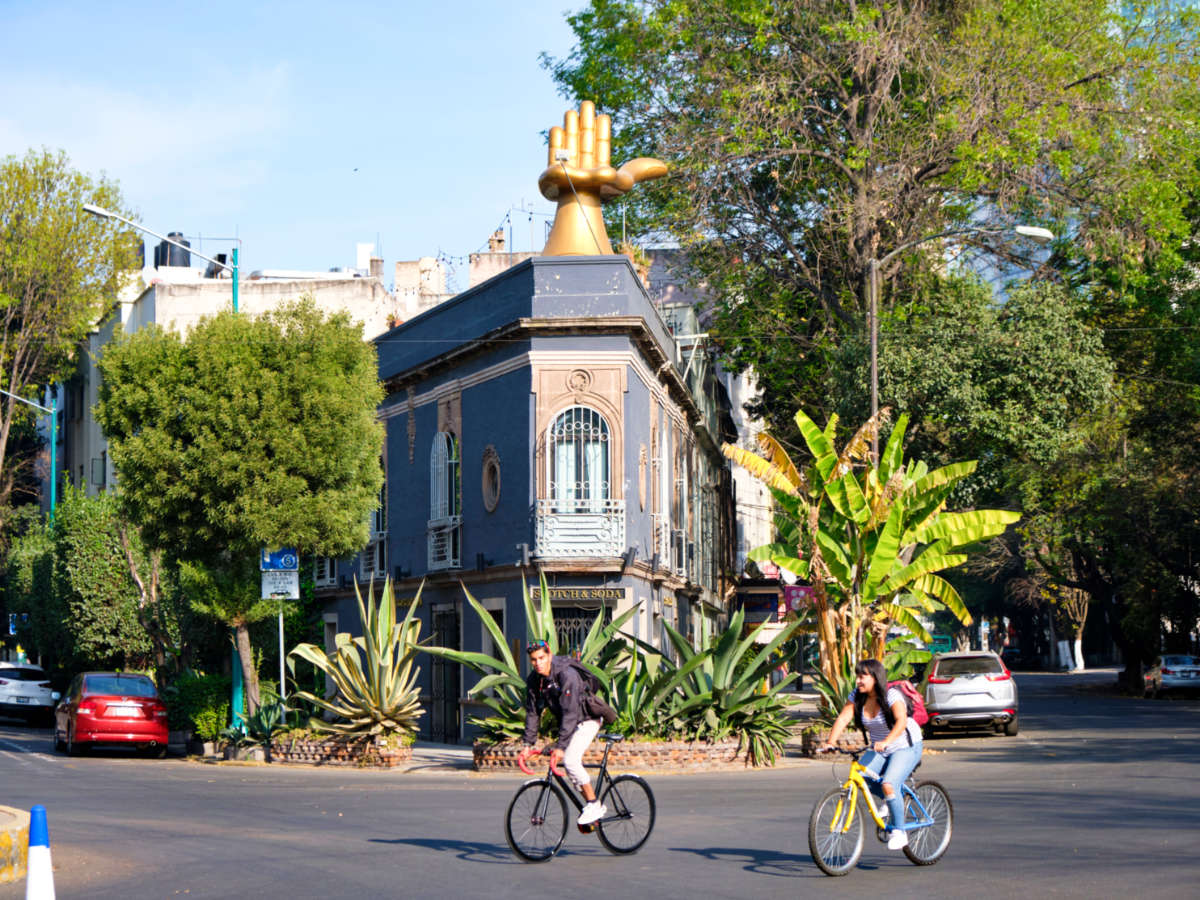 Two cyclists riding around the neighborhood at La Condesa