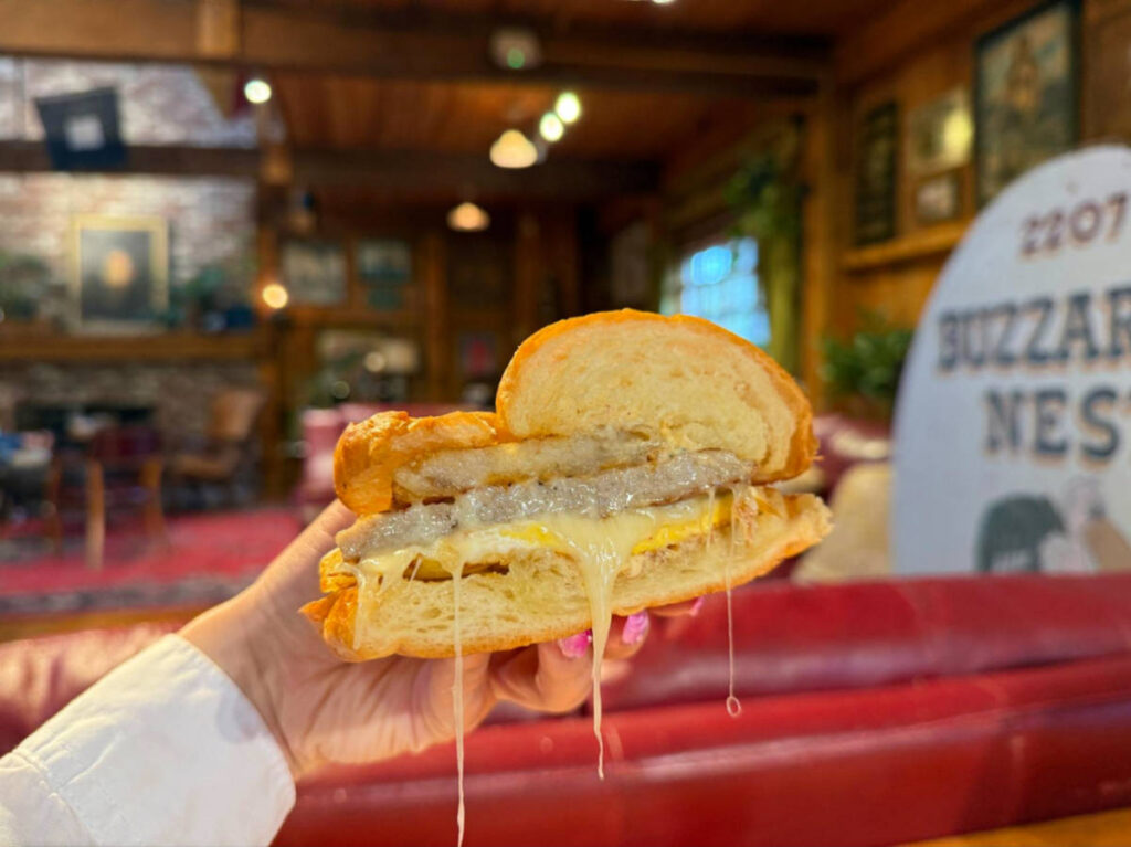 Holding a Cleveland Ledge breakfast sandwich from Daily Brew