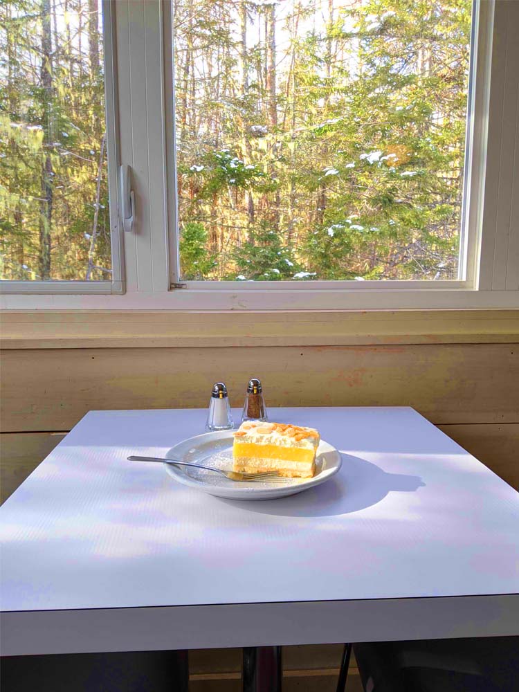 A plate of cake on a table inside Dancing Goat