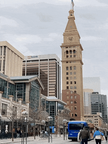 View of the people roaming around the street near the Daniels and Fisher's Clock Tower in Denver