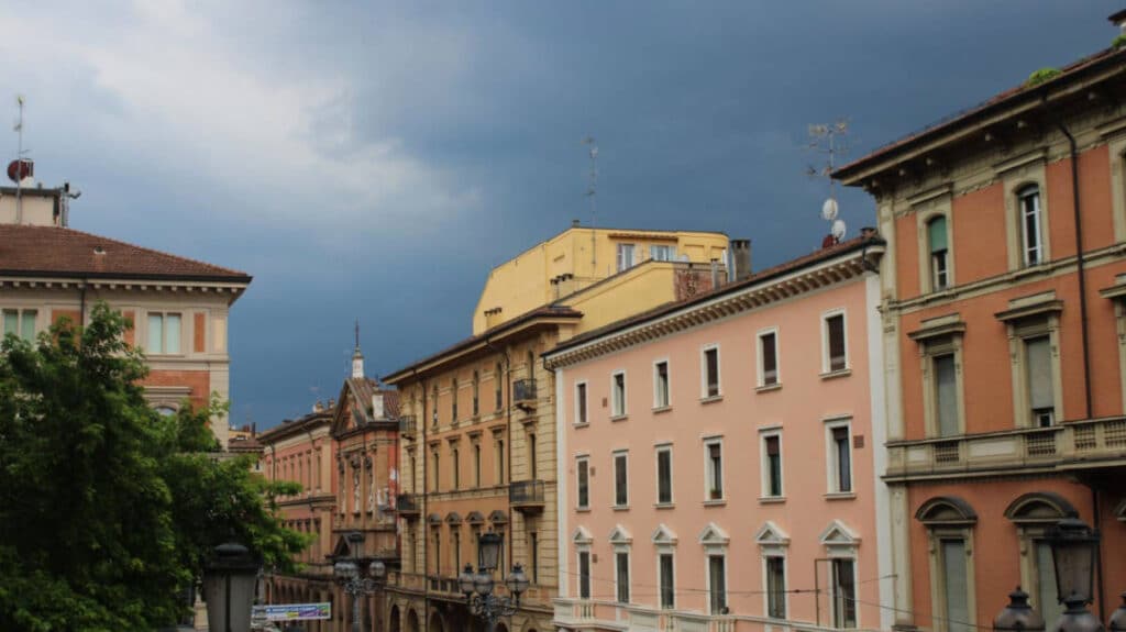 Dark sky over a colorful neighborhood in Bologna