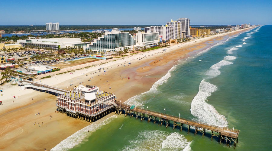 Aerial view of a pier and the residential area in Daytona Beach