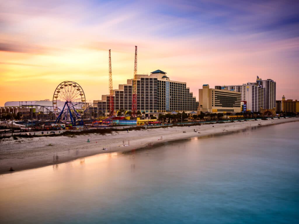 View of the amusement park and the Florida skyline in Daytona Beach during sunset