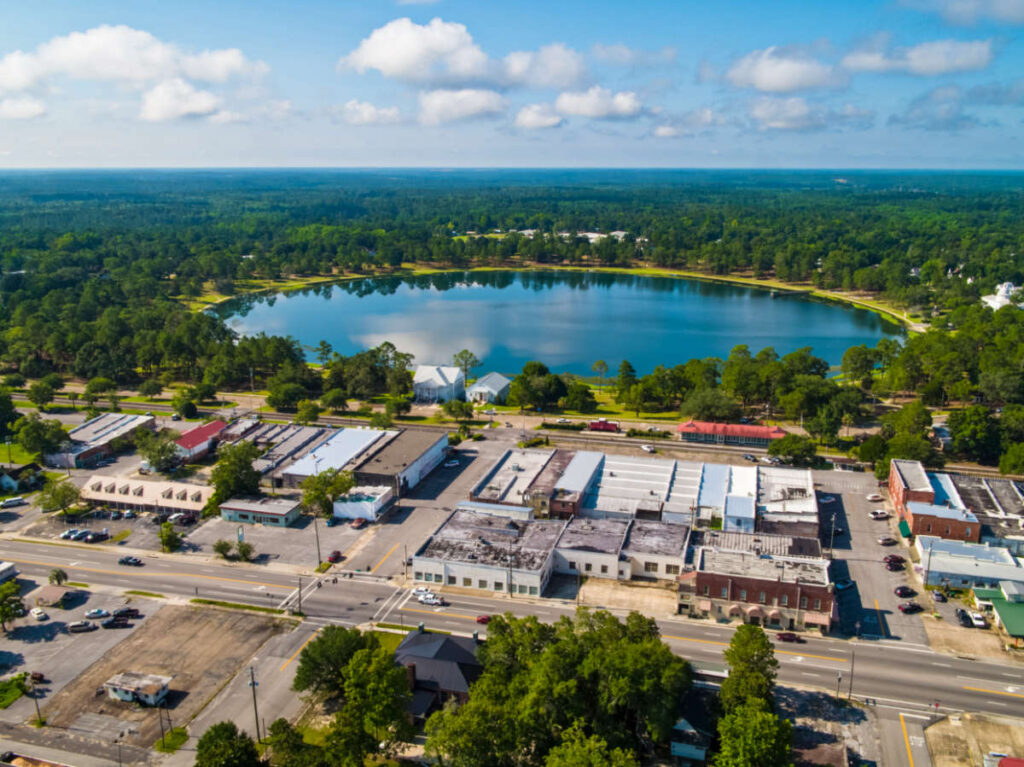 Aerial view of the Lake DeFuniak surrounded by the greenery near DeFuniak Springs