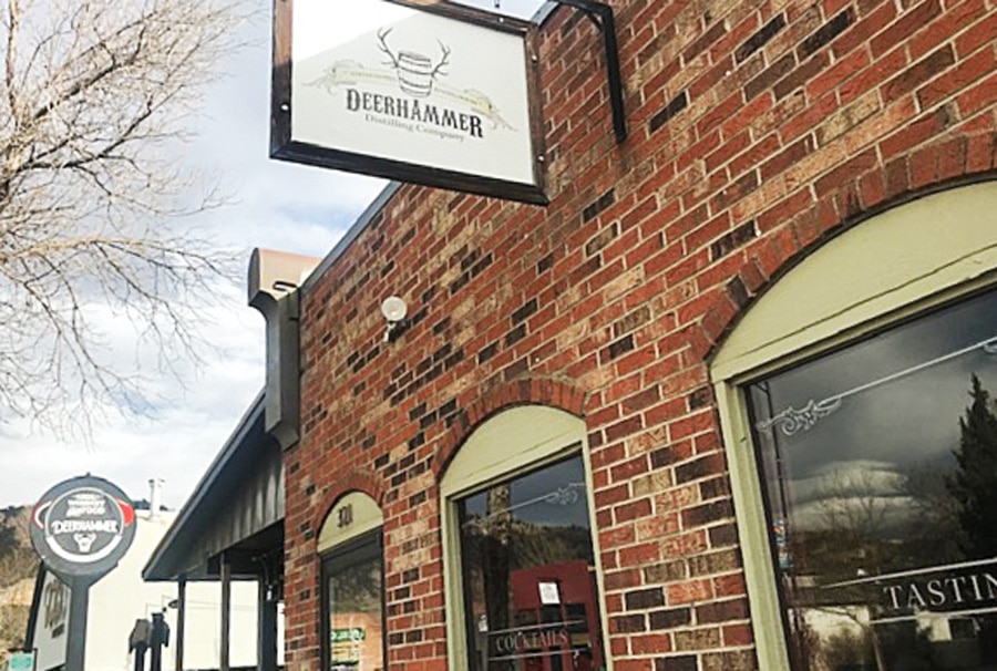 View of the Deerhammer Distilling Company from the outside and its sign