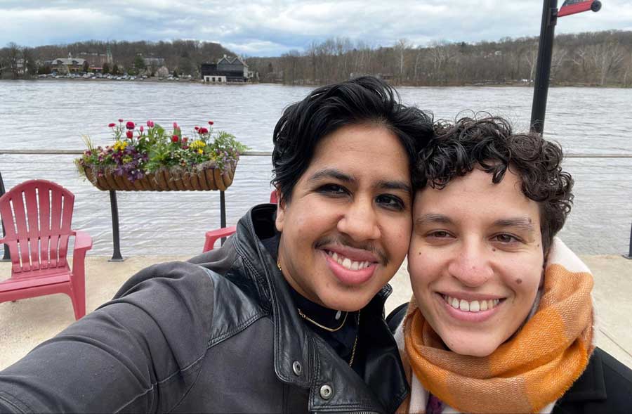 The author with her partner smiling for a selfie with the Delaware River on the background
