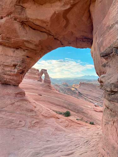 View of an arch from another arch in Delicate Arch Trail