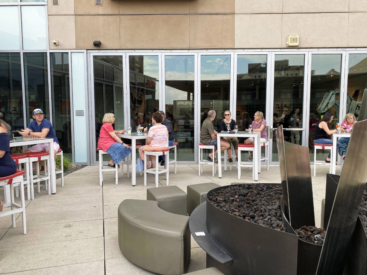 People enjoying their day at the outdoor dining area in Denver Art Hotel