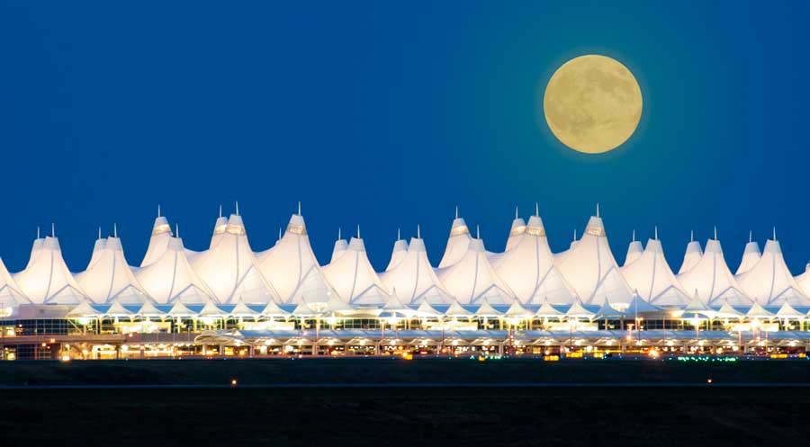 View of a full moon over the Denver International Airport at night