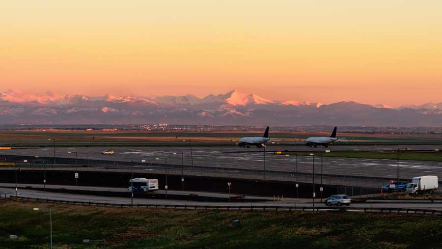 The Denver International Airport under the colorful sky during sunset in Colorado