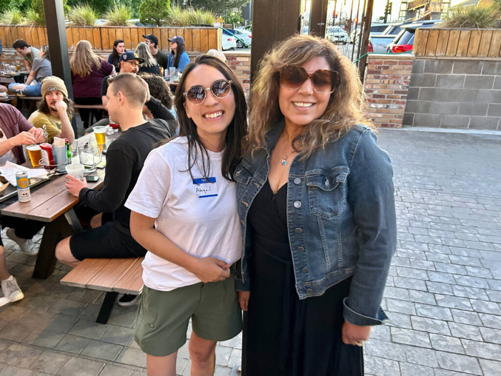 Abigail Bliss and a woman smiling for a photo during the Travel Lemming's Denver Meetups