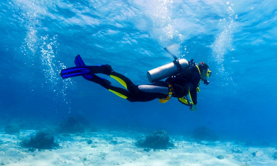 View of a scuba diver at the bottom of the sea