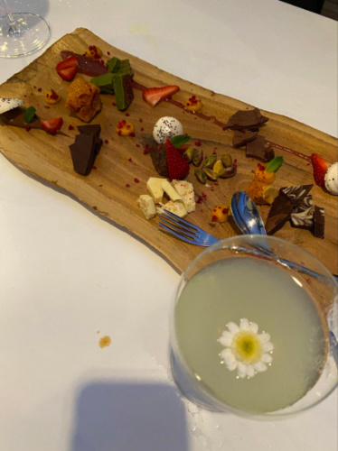 View of Dessert board and floral cocktail on a table at The Deck at 264