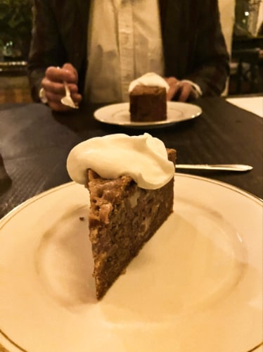 A plate of sliced cake topped with cream from The Corson Building