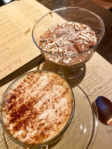 Two glasses of oat cappuccino and chocolate mousse topped with pecans from Emilia’s Crafted Pasta