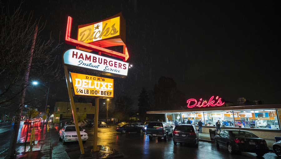 Dick's Hamburgers illuminated sign and establishment at night