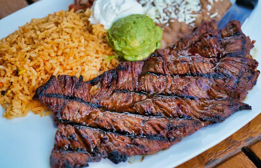 Juicy steak on a plate with rice in Dick’s Hideaway
