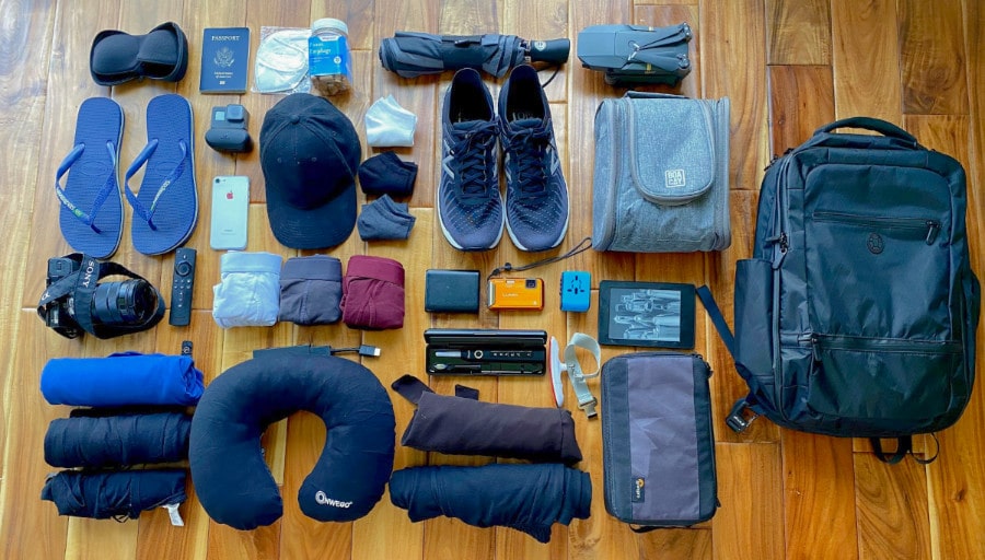 Picture of several digital nomad essential packing items laid out on a floor
