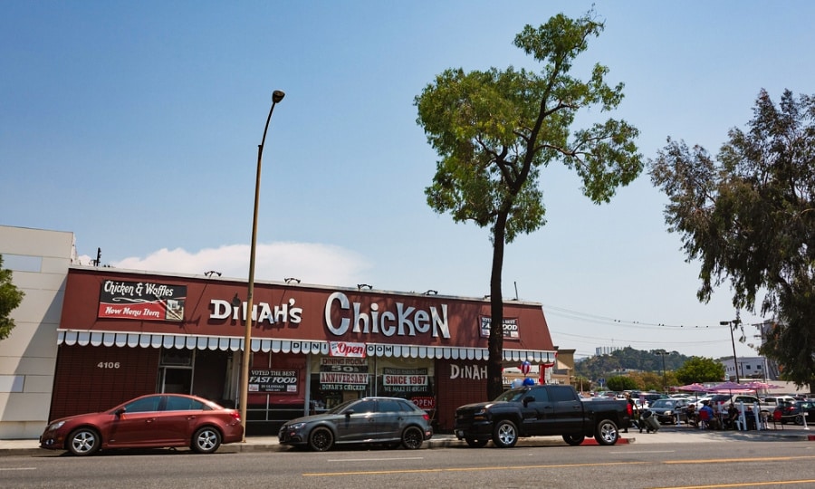 Parked cars outside an old diner of Dinah’s Chicken