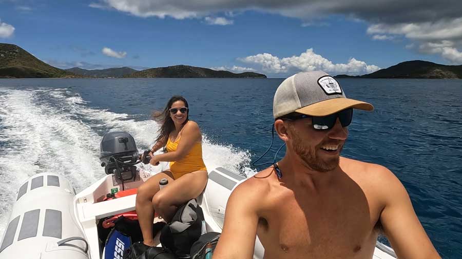 The author with his wife riding on the dinghy that they've rented in St. John