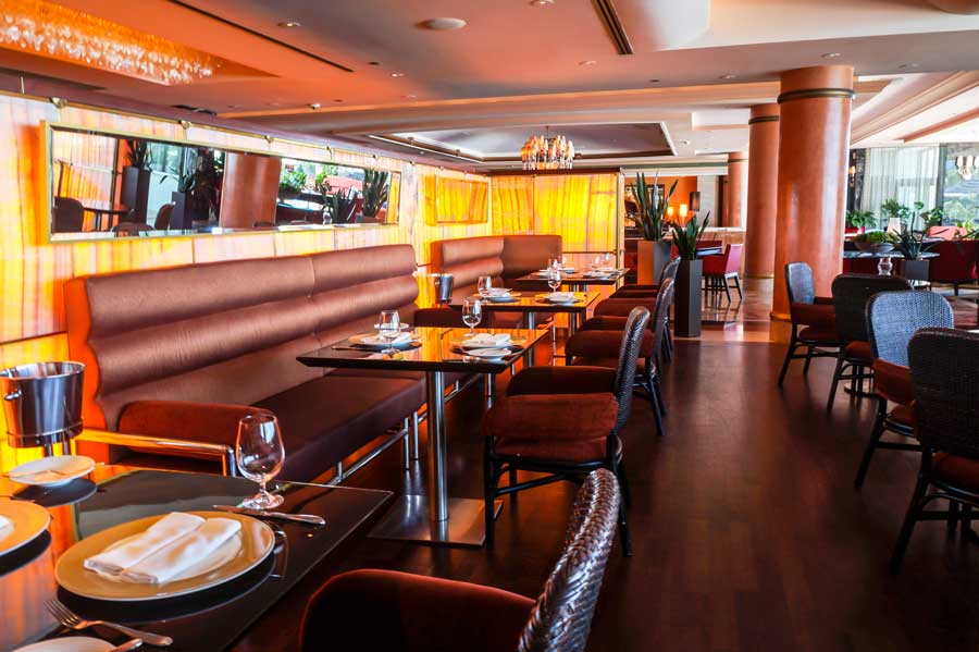 View of tables and chairs from a dining area in Condado Vanderbilt Hotel